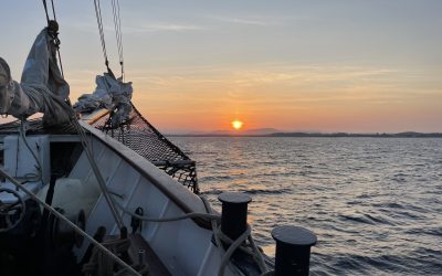 Sunset over the bow tallship Blue Clipper