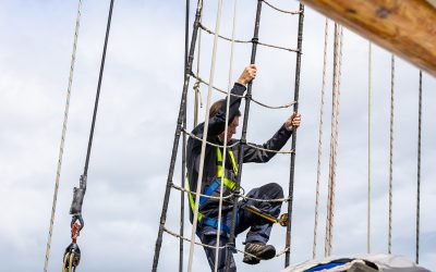 Guest climbing the rigging on Blue Clipper